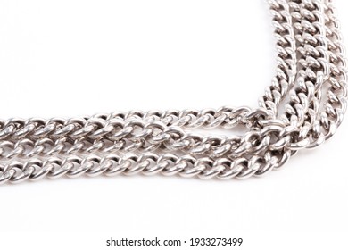 A silver coloured chain on a white background