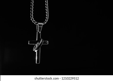 Silver cross in the dark - Shutterstock ID 1210229512