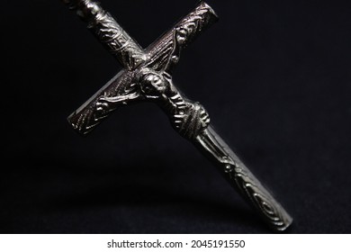Silver cross. God protect written on it. Jesus served his life to save people and bring peace to world. Christianity is pure religion.
