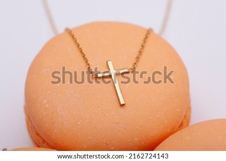 Silver cross necklace decorated with macarons. Image for e-commerce, online selling, social media, jewelry sale.
