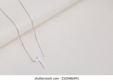 Silver Cross Necklace On The Floor. Jewelry Images That Can Be Used In E-commerce, Online Sales And Social Media.