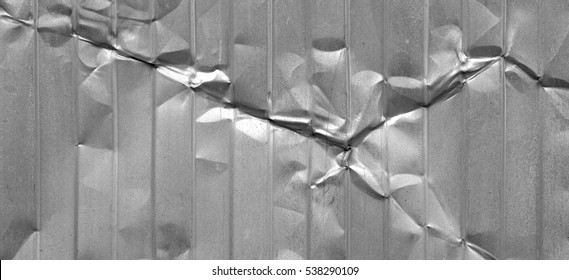 Silver Crumpled Metal Sheet Background. Iron Messy Creased Gray Texture. Corrugated Tin Surface. Damaged Urban Barrier