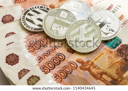 Silver crypto coins Litecoin LTC, Russian rubles. Metal coins are laid out in a smooth background to each other, close-up view from the top, crypto currency exchange of money.