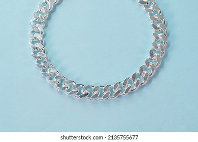 Silver Cuban Chain Link Bracelet On Blue Backbround