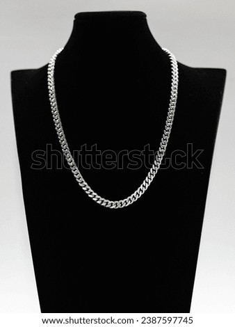 Silver Cuban chain link necklace on black mannequin