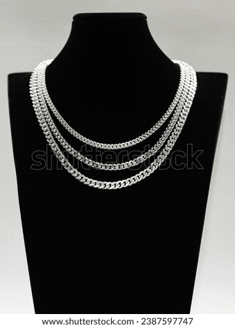 Silver Cuban chain link necklace on black mannequin