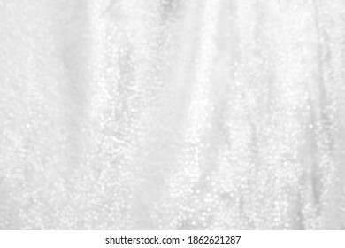 A Silver Curtain, Showing the Circular Bokeh Balls of the Sparkled Fabric with a Hanging Wave to the Material.