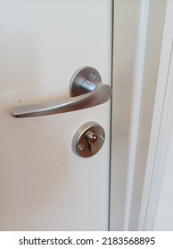 Silver Doorknob On White Door