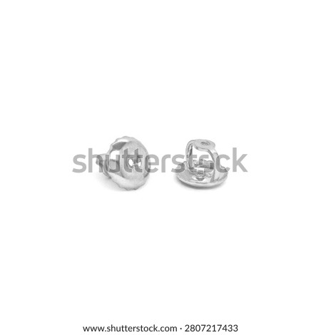 silver earring pushbacks on white background
