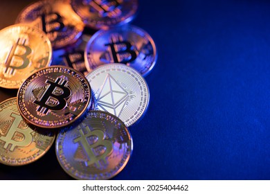 Silver Ethereum coin on dark background. Bitcoin and Ethereum coins illuminated. Crypto currency trading concept. Copyspace on right side - Shutterstock ID 2025404462