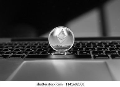 Silver Ethereum coin on a laptop keyboard. Exchange, bussiness, commercial. Profit from mining crypt currencies. Miner with ethereum coin.