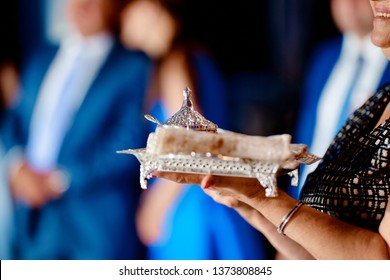 Silver Family Heirloom With Tablecloths On A Tray On Women's Hands At A Wedding