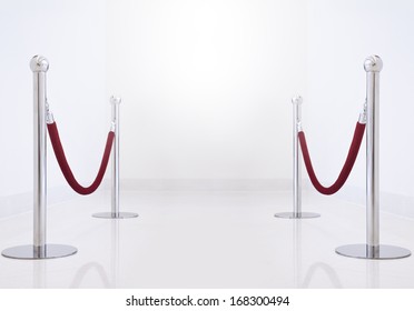 silver fence, stanchion with red barrier rope. - Shutterstock ID 168300494