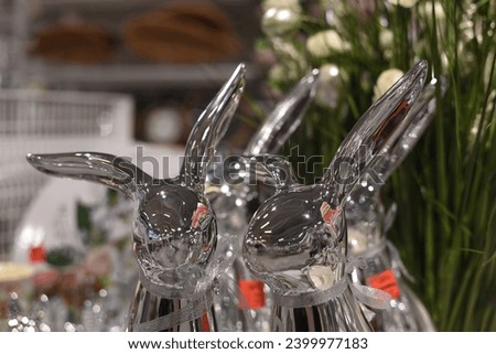 Silver figurines of rabbits in eggs. Easter.