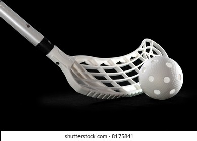 A Silver Floorball Stick And White Ball