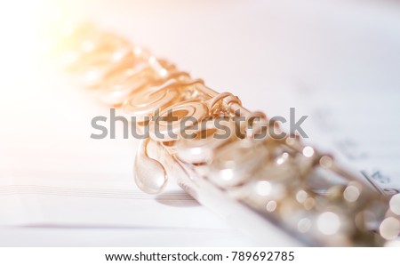 Silver flute on an ancient music score background.
musical instrument