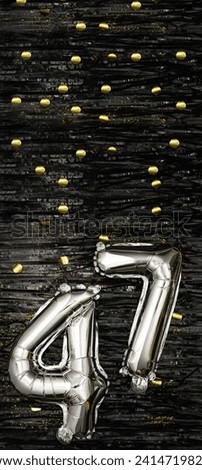 Silver foil balloon number 47 on a background of black tinsel with gold confetti. Birthday card, inscription forty-seventh. Anniversary event. Vertical banner. copy space.