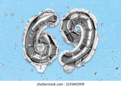 Silver Foil Balloon Number, Digit Sixty Nine On A Blue Background With Sequins. Birthday Greeting Card With Inscription 69. Top View. Numerical Digit. Celebration Event, Template.