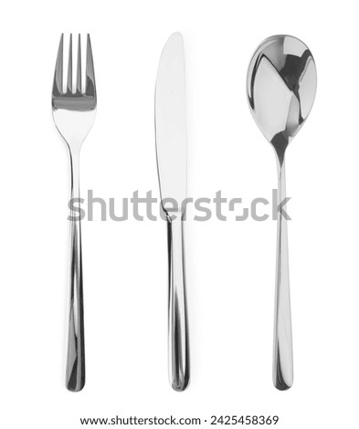 Silver fork, knife and spoon isolated on white, top view