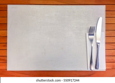 Silver Fork and knife with White Napkin Top View on wooden table background