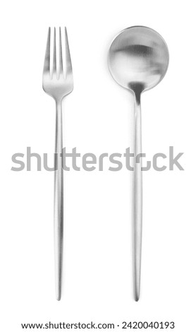Silver fork and spoon isolated on white, top view