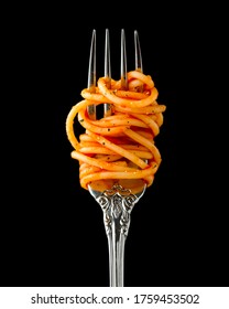 Silver fork wrapped in spaghetti with tomato sauce