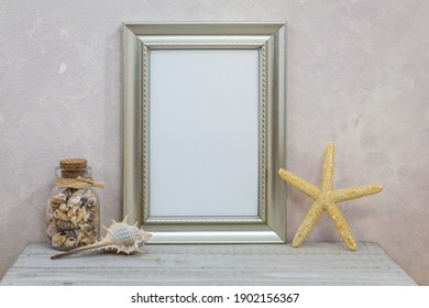 Silver Frame Mockup With With Seashells Against Pink Textured Wall For Spring, Summer, Sea, Seashore, Beach, Vacation, Holiday, Party Theme.