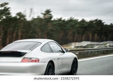 Silver German Roadster Coupe: Exquisite Speed and Style on the Majestic Highway. Modern European Sportcar. - Shutterstock ID 2338272595