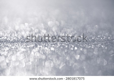 Silver glitter texture background. Silver bokeh sparkle background. Silver shimmering abstract backdrop. Silver festive glitter pattern.