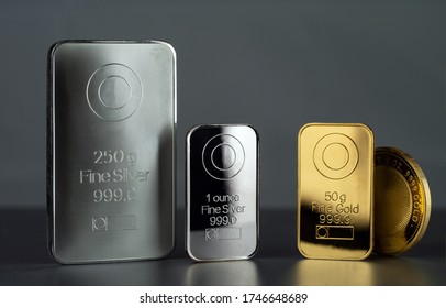 Silver and gold bars and coin on a dark background. - Shutterstock ID 1746648689
