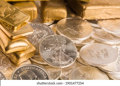 silver and gold bullion on the table - Shutterstock ID 1901477254