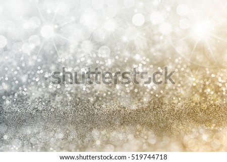 Silver and gold Christmas background with graduated bands of different sparkling and twinkling bokeh from party lights and glitter, full frame copy space