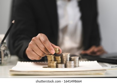 Silver and gold coins stacked on the work desk,Money for business, growth and investment - Shutterstock ID 1641498664