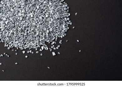 Silver Granules. Pile Of Small Silver Particles On Dark Gray Background