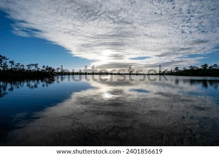 Silver gray afternoon cloudscape over Pine Glades Lake in Everglades National Park, Florida.