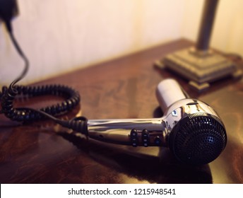 Silver Hair Dryer On A Wooden Dressing Table