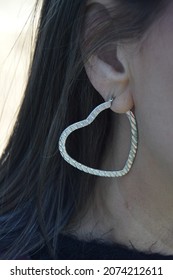 Silver Heart Earring Hanging From Ear