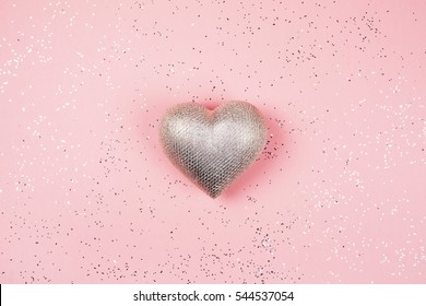 Silver Heart On Pink Background With Sparkles. Valentines Day Concept. Flat Lay Style.