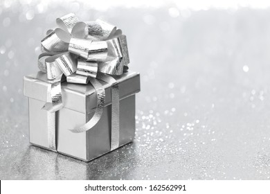 Silver Holiday Gift On Glitter Background