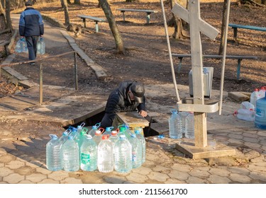 Silver holy spring in the Seversky district. People collect pure spring water in plastic bottles. Krasnodar region. Russia, Krasnodar. November 30, 2021
