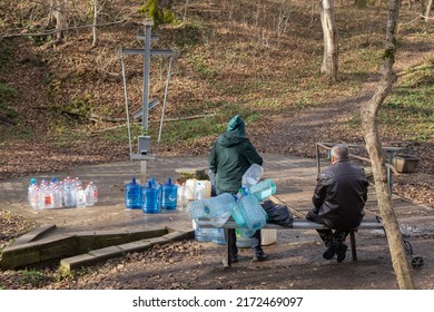 Silver holy spring in the Seversky district. People collect pure spring water in plastic bottles. Krasnodar region. Russia, Krasnodar. November 30, 2021