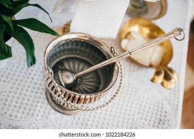 Silver Holy Water Bucket And Sprinkler In A Church