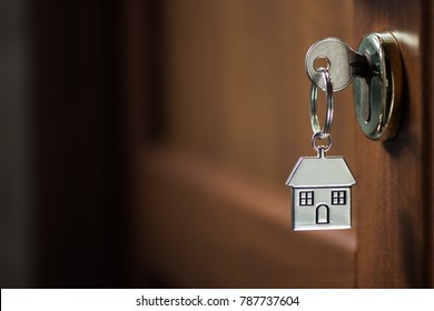 Silver House Key In A Door