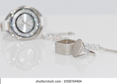 Silver Jewelry With Pearls And Cubic Zirconia On A Background Of Elegant Women's Watches