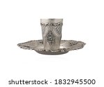 Silver kiddush cup in a tray isolated on a white background.