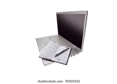 Silver lap top with opened pocket planner and silver pen