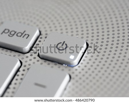Silver laptop power button close up. Shallow DOF