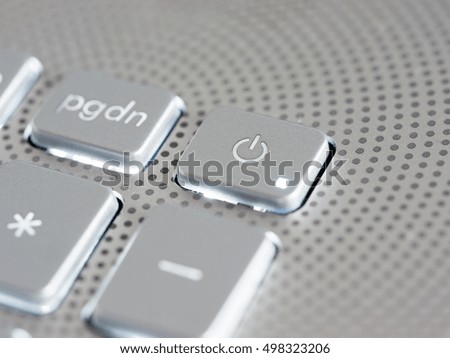 Silver laptop power button close up. Shallow DOF