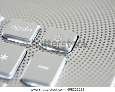 Silver laptop power button close up. Shallow DOF