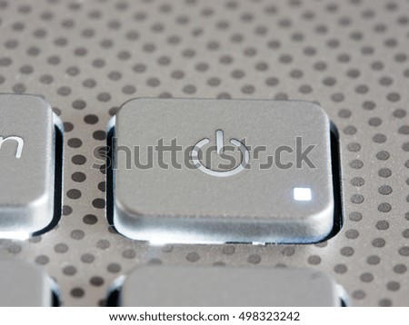 Silver laptop power button close up. Shallow DOF